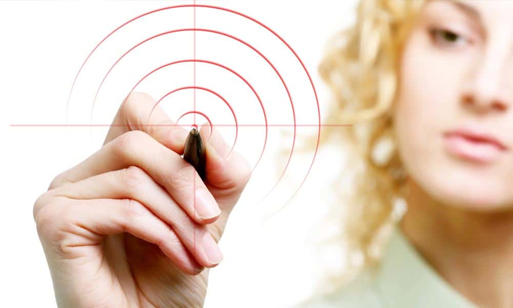 blonde woman drawing a target with a marker