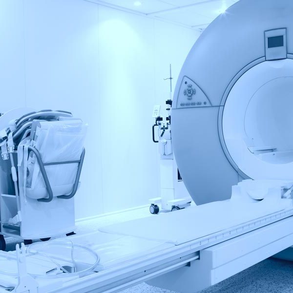 empty mri machine not in use in a white room with no patient present